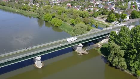 Aerial-view-of-a-boat-crossing-the-aqueduct-at-Briare,-France,-Europe