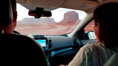 Inside-gimbal-stabilized-shot-of-car-driving-in-Monument-Valley,-Arizona,-USA-at-sunset