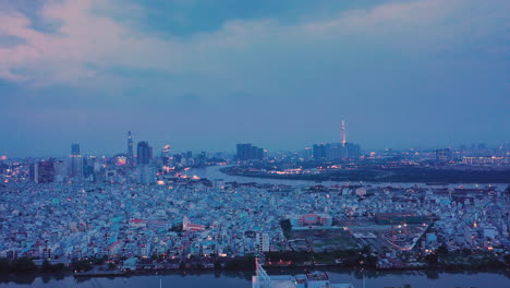 Spectacular-night-time-aerial-Panorama-of-Ho-Chi-Minh-City-,-Vietnam-sparkling-under-lights-and-reflections-on-the-saigon-river