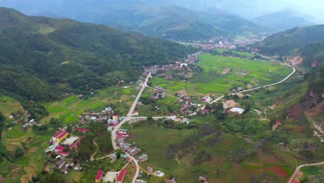 Slow-aerial-tilt-up-of-a-Vietnamese-farming-community-settled-in-the-misty-mountains
