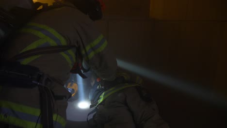 Firefighters-rescues-an-injured-firefighter-inside-a-smoky-burning-building