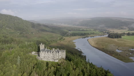 An-aerial-view-of-Carbisdale-Castle-on-a-sunny-morning-with-cloudy-skies