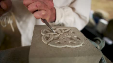 A-stonemason-demonstrates-the-carving-of-sandstone-at-the-festival