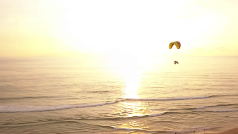 Sonnenuntergang-Luftdrohnenfahrt-Von-Paramotorfahrern-über-Einem-Strand-In-Weligama,-Sri-Lanka