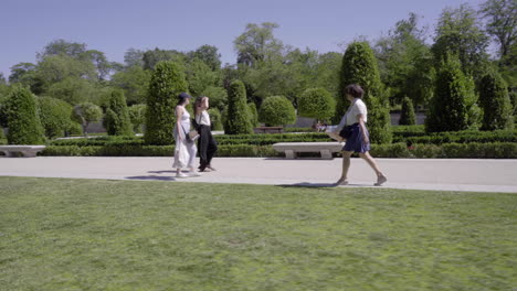 Hand-held-tracking-shot-of-woman-walking-in-park
