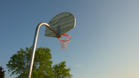 Basketball-net-from-behind-on-a-beautiful,-clear-morning