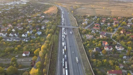 Aerial-drone-view-over-moving-and-stopped-traffic-on-six-lane-highway
