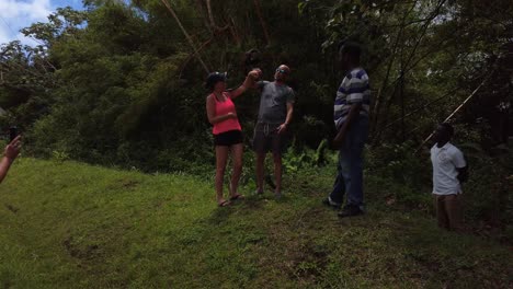 Mona-monkey-eating-from-tourist-hands-in-the-rainforest-of-Grenada