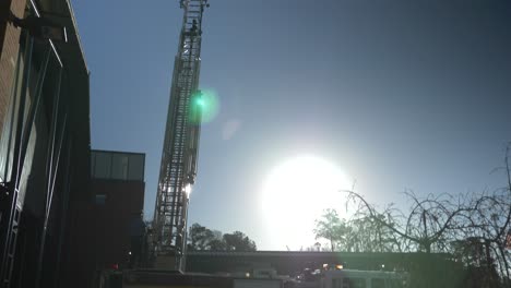 Firefighter-tests-a-long-extension-ladder-on-a-fire-truck-used-for-emergency-response-and-firefighting