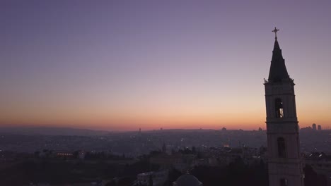 Aerial-footage-of-a-large-church-tower-in-old-city-Jerusalem-during-sunset