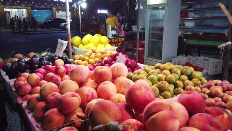 Wulingyuan,-China---August-2019-:-Various-fruits-on-sale-in-a-stall-on-a-night-street-market,-Hunan-Province
