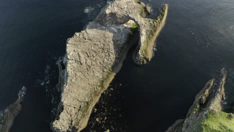 An-aerial-view-of-Bow-Fiddle-Rock-at-Portknockie-on-a-calm-summer's-morning