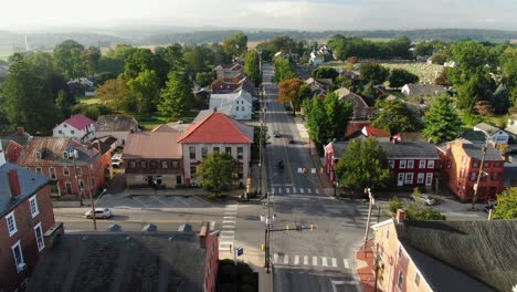 Descending-aerial-of-intersection-with-horse-and-carriage-and-traffic-at-intersection