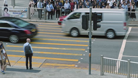 Pedestrians-using-a-road-crossing-during-morning-rush-hour-in-the-Central-district