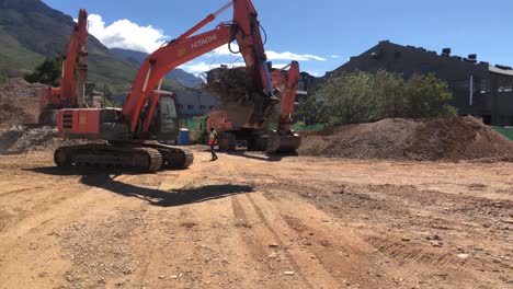 wide-shot-of-Hitachi-ZAXIS-excavators-working-on-a-construction-site-in-Cape-Town,-South-Africa