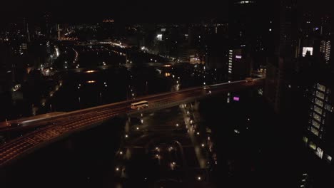 Osaka-City-overpass-in-Nakanoshima-on-dark-moody-night,-Aerial-View