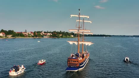 Orbiting-around-a-brige-type-sailing-ship-full-of-passengers-sailing-on-the-lake