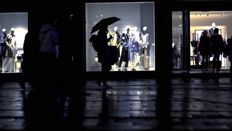 People-crossing-the-street-during-a-wet-rainy-night-in-Munich