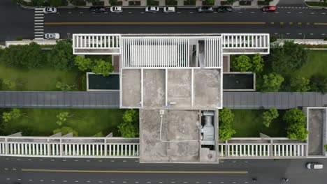Top-down-tracking-Aerial-shot-featuring-rooftop-gardens,-swimming-pools-and-streets-of-contemporary-luxury-residential-real-estate-development-in-Thu-Thiem,-district-2-of-Ho-Chi-Minh-City