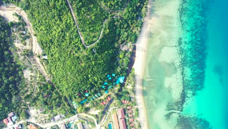 Paradise-tropical-island,-luxury-resorts,-white-sand-beach-hill-with-exotic-trees,-aquamarine-sea-water