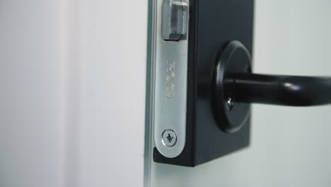 Slow-orbit-shot-of-modern-black-metal-door-handle