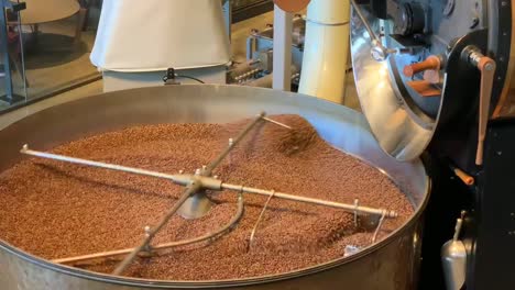 Fresh-aromatic-coffee-beans-spinning-around-a-factory-sized-coffee-roaster-at-the-Starbucks-Reserve-Seattle-Roastery