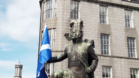 Slow-motion-of-a-Gordon-Highlanders-Statue-holding-the-Saltire-at-a-pro-Scottish-Independence-march