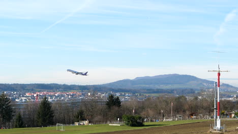 Wide-body-airliner-take-off-from-Zurich-Airport-runway,-lockdown-shot