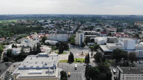 Aerial-View-of-City-in-Eastern-Europe-Featuring-Roads,-Buildings,-and-Fields-in-Background