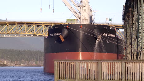 The-Blue-Akihabara-Cargo-Vessel-Anchored-Under-The-Bridge-In-Vancouver---Close-Up-Shot