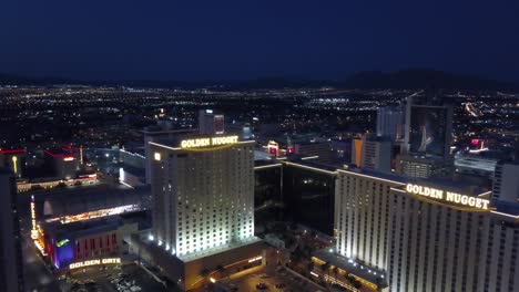 4K-AERIAL:-Slow-aerial-towards-the-Golden-Nugget-Hotel-and-Casino-in-Las-Vegas-with-the-city-lights-in-background-at-dusk