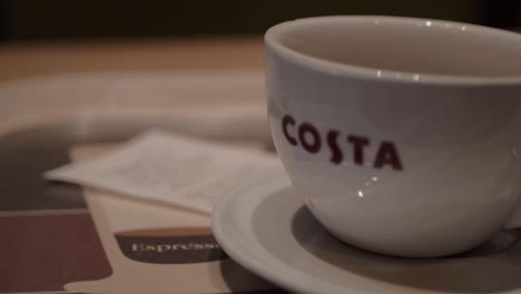 Cup-of-Costa-Coffee-with-till-receipt-on-table