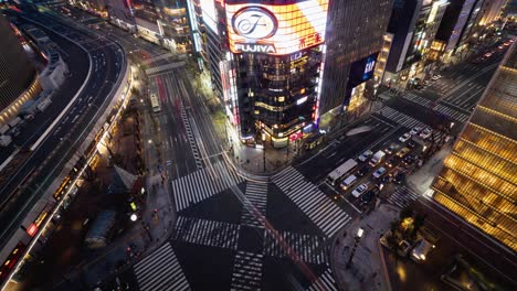 High-angle-view-of-popular-shopping-district-department-stores-and-multi-lane-road-at-night-in-Japans-capital