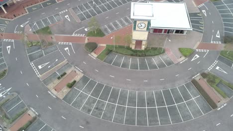Aerial-view-COVID-virus-town-lock-down-retailers-empty-shopping-center-parking-tilt-up
