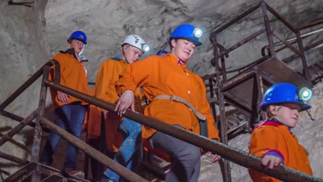 Handheld-shot-group-of-miners-discovering-Mezica-museum-Slovenia