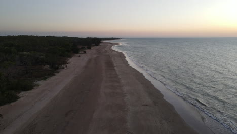 Slow-Moving-Drone-shot-of-Orange-Sunset-and-Empty-Lee-Point-Beach-in-Darwin,-Northern-Territory