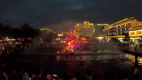 Amazing-light-and-sound-show-in-the-fountains-in-the-central-town-square-at-dusk-in-Xian,-China