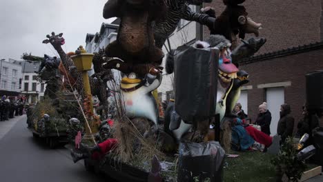 Aalst-festival-parade-wagon-with-animals-and-trolls-moving-and-people-watching-traditional-parade