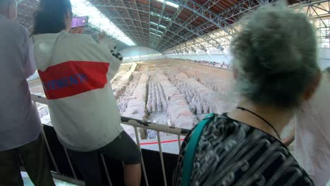 Tourists-inside-the-museum-site-building-containing-Terracota-Army-sculptures,-Xian,-Shaanxi-Province,-China