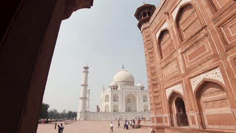 Tourists-walk-on-Taj-Mahal-grounds,-Agra,-India