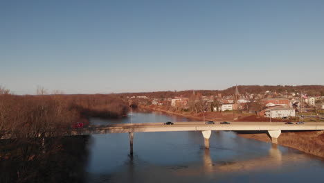 Cars-and-trucks-traveling-across-bridge-spanning-Susquehanna-river-in-Pennsylvania,-Aerial