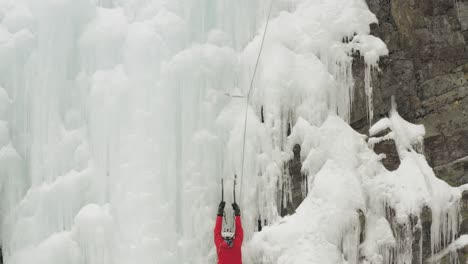 Ascending-aerial-Ice-climbers-scale-cascade-at-Mount-Kineo,-Maineline