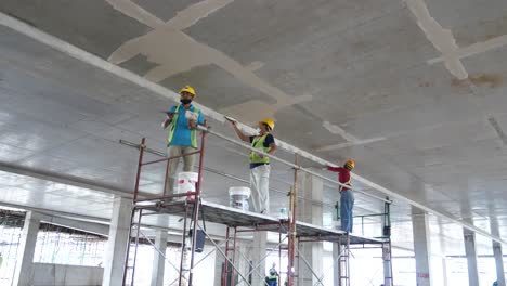 Bauarbeiter-Führen-Auf-Der-Baustelle-Deckenuntersichtsspachtelarbeiten-Durch