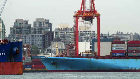 Galaxy-Cargo-Ship-Passing-By-Port-Of-Vancouver-With-Container-Ship-And-Skyline-Buildings-In-Background---static-shot