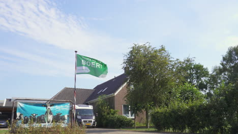Wide-shot-of-a-dairy-farm-in-The-Netherlands-showing-a-protest-flag
