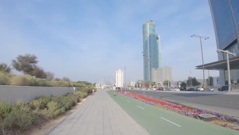 City-traffic-infrastructure,-one-person-rides-electric-scooter-on-bike-path