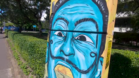 Strolling-past-a-blue-mural-on-a-post-box-in-Brisbane,-Australia