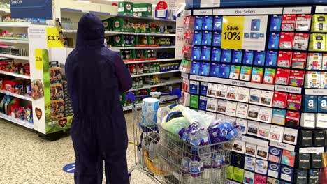 Shopper-in-full-Hazmat-suit-in-Tescos-supermarket,-Whitstable,-Kent-UL