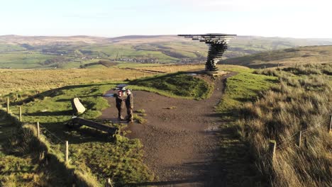 Aerial-singing-ringing-tree-musical-panopticon-sculpture-in-Lancashire-hiking-countryside-push-in-flyover-close