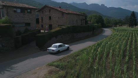 Aerial-shot-of-BMW-e30-car-driving-on-country-road
